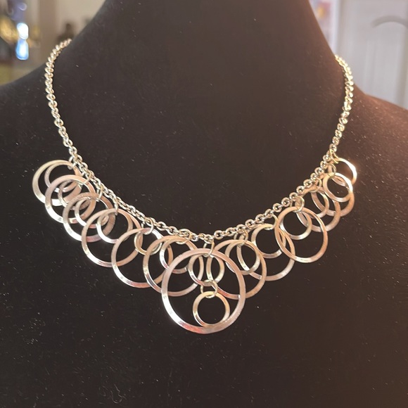 Light silver toned necklace with a variety of circles suspended on silver chain - Picture 1 of 13